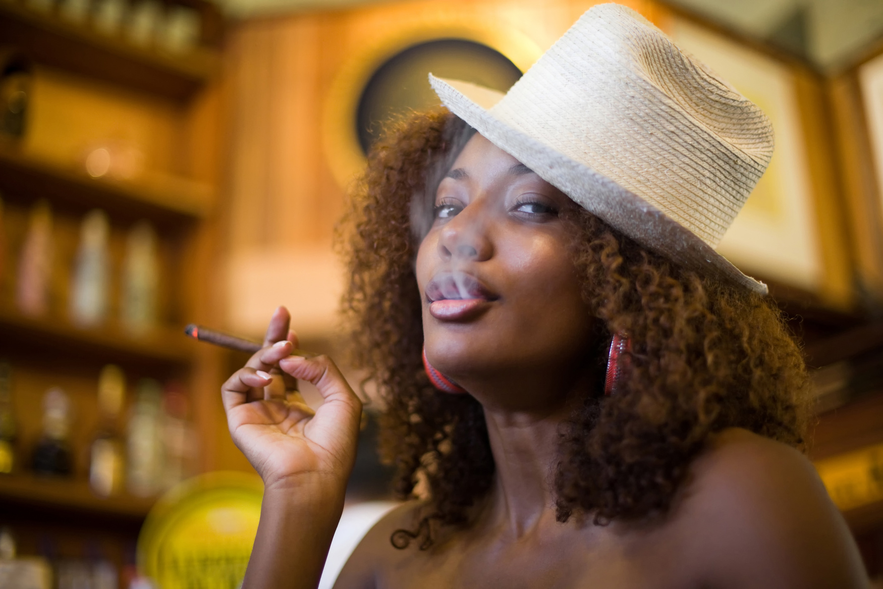 Cute black woman smoking cigar